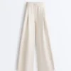 Broek met wijde pijpen, piqué en plooien, met katoen Broek met wijde pijpen, piqué en plooien, met katoen