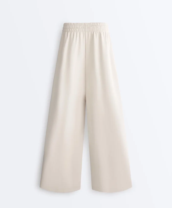 Broek met wijde pijpen, piqué en plooien, met katoen Broek met wijde pijpen, piqué en plooien, met katoen